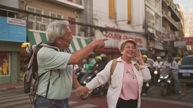Asian senior couple traveler traveling and exploring the city outdoors. 