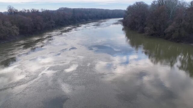 Tisza drifting downstream on a river in winter