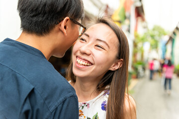 Fototapeta premium Joyful couple sharing laughter outdoors.
