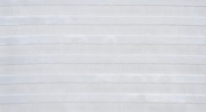 Macro view of white ribbed cotton fabric texture with parallel horizontal lines and detailed weave