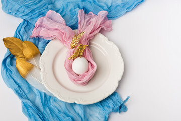 Elegant flat lay table setting featuring an ornate porcelain dish centered in the frame
