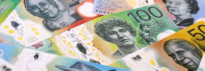 Australian dollar money bills pile on table. Australia banknotes of AUD currency close up.