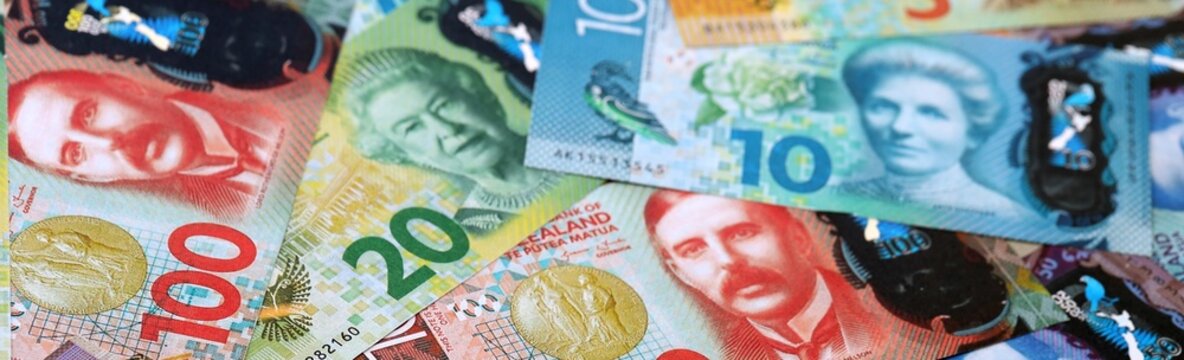 New Zealand dollar money bills pile on table. New Zealand banknotes of NZD currency close up.