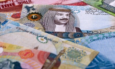 Bahraini dinar money bills pile on table. Bahrain banknotes of BHD currency close up.
