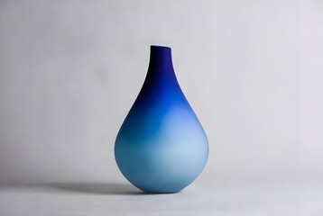 Fototapeta premium A minimalist, gradient blue vase, elegant design, ideal for artistic, clean style, interior decor or home design.