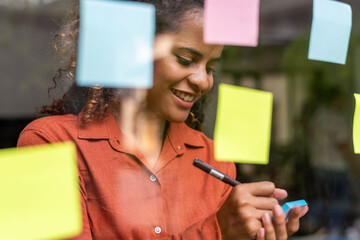 Woman writing colorful sticky notes
