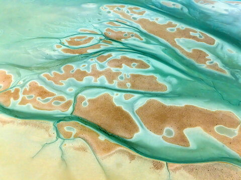 Aerial view of sandbar patterns in tranquil turquoise water create a mesmerizing tapestry of nature's artistry, Al Nouf, Abu Dhabi, United Arab Emirates.
