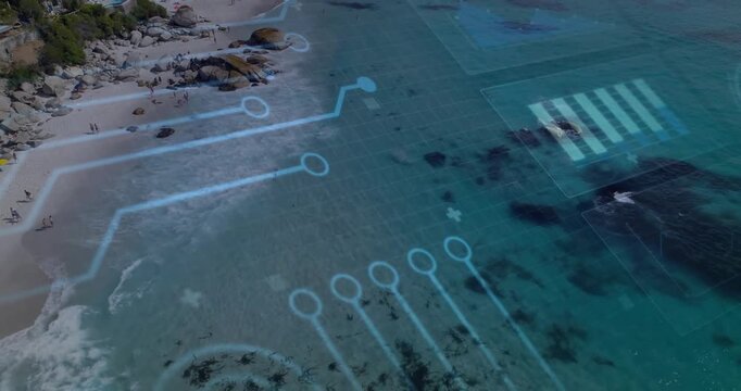 Aerial camera sweeping coastline starting circuit overlay moving across turquoise sea, showing grid