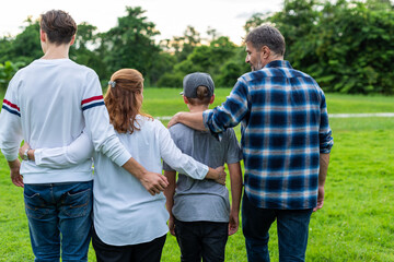 Family walking together outdoors.