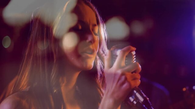 Female singer starting to sing while camera closing on retro mic, bokeh drifting, emoting for music