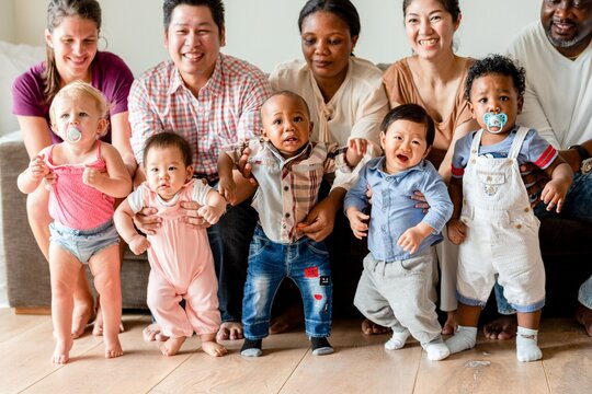 Diverse joyful toddlers with parents