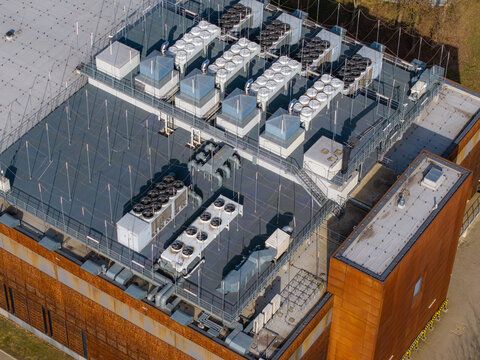 Modern data center rooftop managing thermal regulation with multiple hvac units and ventilation systems for compute infrastructure, Warsaw, Masovian Voivodeship, Poland.
