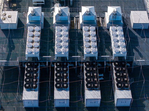 Rooftop area with numerous hvac cooling units, fans, and ventilation systems maintaining optimal conditions for a data center, Warsaw, Masovian Voivodeship, Poland.