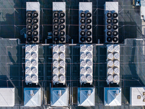 Data center rooftop with numerous cooling units and ventilation systems, providing essential infrastructure for computing technology, Warsaw, Masovian Voivodeship, Poland.