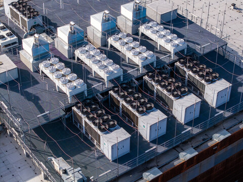 Rooftop data center infrastructure with multiple hvac cooling units and ventilation systems managing temperature for servers, Warsaw, Masovian Voivodeship, Poland.