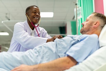 Fototapeta premium Doctor caring for hospital patient.