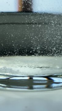 Salt falls. Salt. A glass of water. Epsom salts. Slow motion video. High quality 4k footage