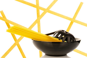 Uncooked spaghetti isolated on white background, close-up.