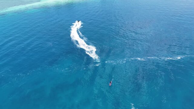 Aerial Drone View of Jet Ski and Stand Up Paddleboard in Clear Ocean Water