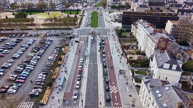 Boulevard du Mar&eacute;chal Foch with tram and traffic, the Jardin du Mail park, and City Hall in Angers, France. Aerial forward tilt-up reveal