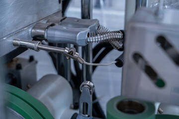 Industrial wiring with spring protectors and sensors on automated machinery.