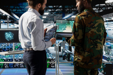 Black military soldier works with engineer to strengthen national defense systems, protecting...