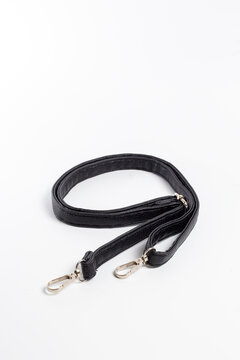 Top view of black nylon bag strap with two gold-tone carabiners