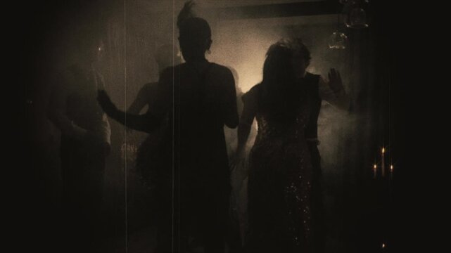 old film 1920s style black and white sepia color silhouette group of people dancing crowd in dark night club. Sexy girl flapper female male have fun at dance floor retro partynew year roaring twenties