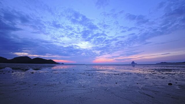 Expansive blue crepuscular sky over low tide shoreline in Thailand