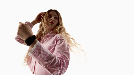 Young woman wearing smartwatch showing wrist isolated on white background. Concept of wearable technology, gadget advertising, mobile app interface, fitness tracking and digital lifestyle products.