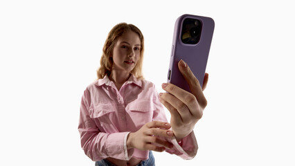 Young woman using smartphone isolated on white background. Concept of mobile application usage, digital communication, smartphone interface interaction and modern technology lifestyle.