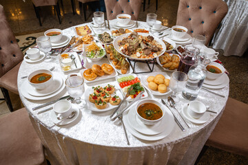 Fototapeta premium Kazakh national dastarkhan top view with traditional dishes and decor.