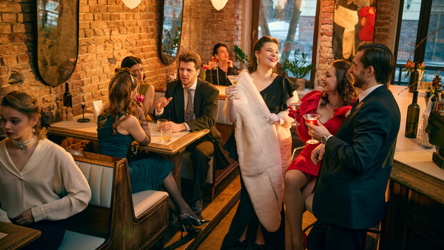 Retro friends socializing with cocktails in stylish brick wall lounge. Concept of networking event visuals, upscale venue presentation and hospitality brand storytelling.
