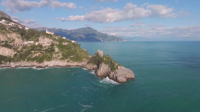Aerial view of the rugged coastline and turquoise waters, where the towering cliffs meet the sea, Conca dei Marini, Campania, Italy.