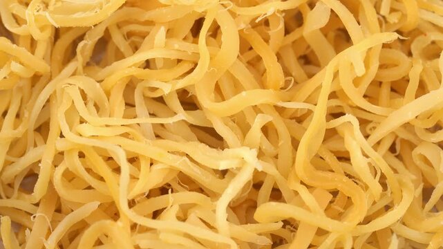 Beer snack made of dried squid. Dried squid isolated on white background. Dried squid shavings. Small fish, shrimp and squid that have been marinated with salt and dried