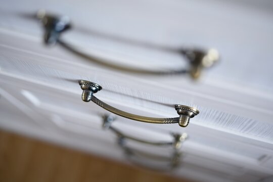 Hot plates on white electric stove close up, there are casserole and pan on hot plates with lids, kitchenware dishes