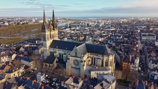 Wide drone establishing shot of the city of Angers, with Saint-Maurice Cathedral and the Maine river in France. Aerial, cityscape