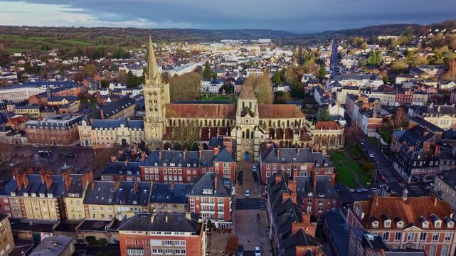 Wide drone view of the historic Saint-Pierre Cathedral and the surrounding cityscape of Lisieux in Normandy, France. Aerial forward