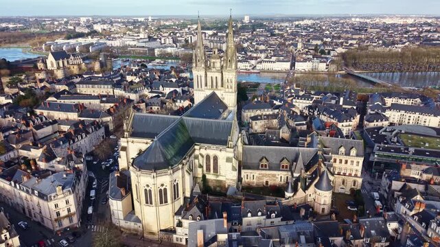 Roof and spires of Saint-Maurice Cathedral, overlooking the city and Maine river in Angers, France. Aerial approach, cityscape