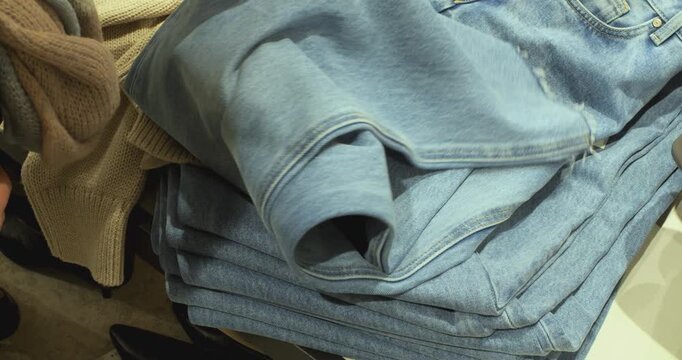 Woman's Hands Checking Fabric Quality at Store