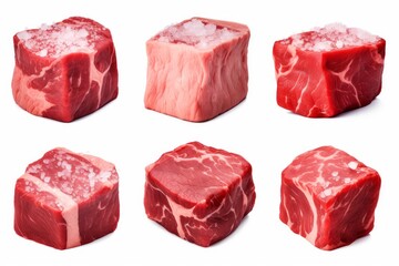 Fototapeta premium Raw beef cubes displaying fresh protein, marbled fat, and sprinkled salt on a white background