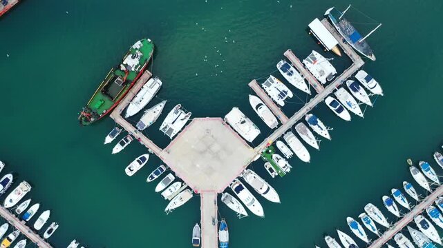 Aerial view of boats docked at Ashdod Marina, a vibrant scene with white boats contrasting against the turquoise water, Ashdod, South District, Israel.