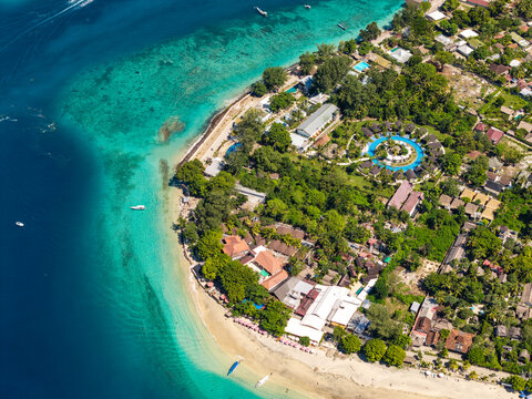 Tropical paradise at Gili Air, Indonesia, featuring luxury resorts and shallow coral reef