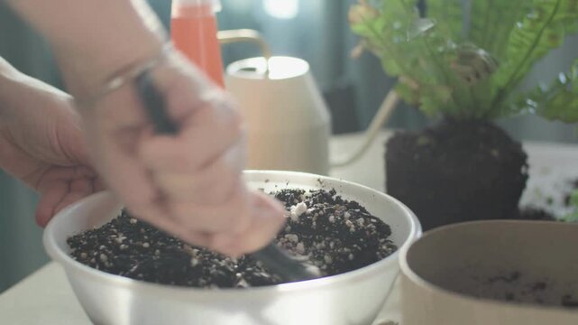 Close-Up of Hands Using Gardening Trowel to Mix Soil and Perlite &ndash; Plant Care and Potting in 4K Video