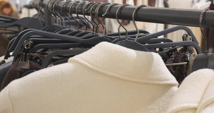 Feeling clothes on hangers before purchasing