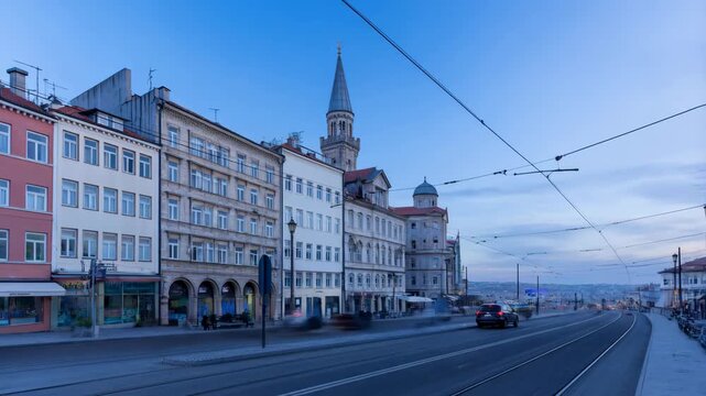 Istanbul's historic street with tram lines and cars at sunset