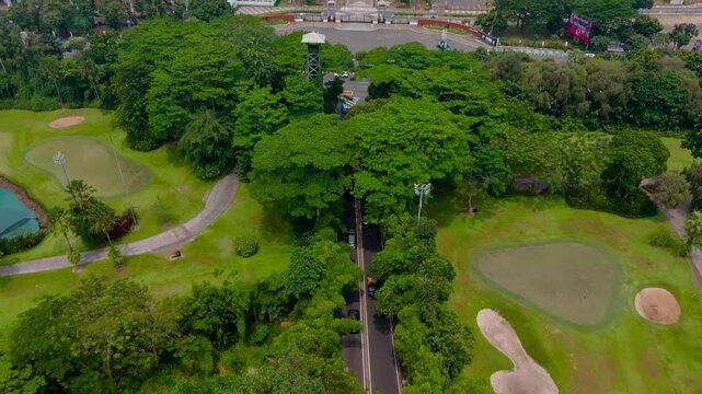 Aerial view of the lush green Gelora Bung Karno Main Stadium area, a blend of verdant golf courses and dense trees, Jakarta, Daerah Khusus Ibukota Jakarta, Indonesia.