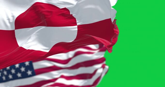 Flags of Greenland and the US waving in the wind isolated on green background