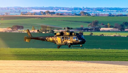 Fototapeta premium Military helicopter over rural fields