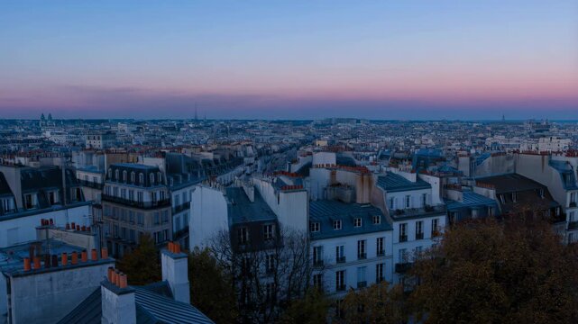 Montmartre with view of Paris cityscape at dawn, soft pink and blue sky featuring timelapse, wide shot, rooftops with buildings and urban landscape